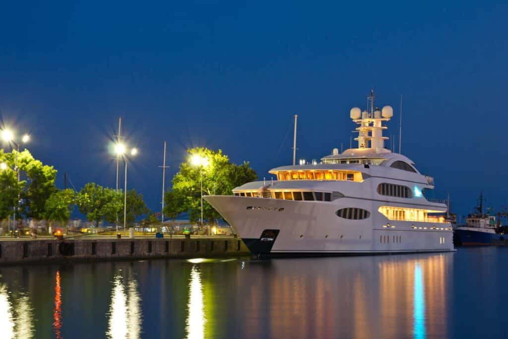 White yacht docked in Marina yard