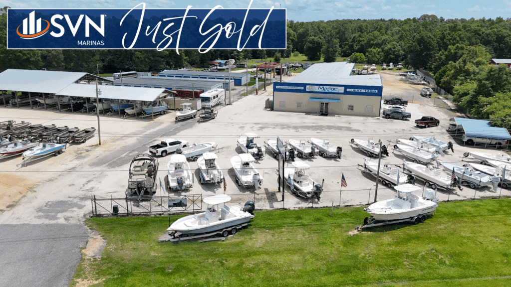 Aerial view of L&M Marine in Stapleton, Alabama, showing the dealership’s boat inventory, covered storage, and service building. Overlaid with the SVN Marinas “Just Sold” banner to announce the sale facilitated by David Kendall, CCIM.