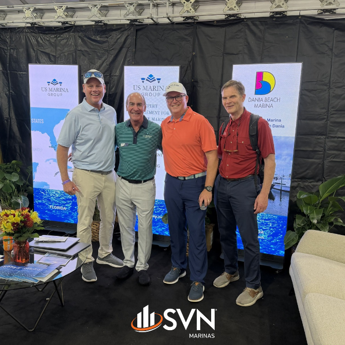David Kendall and Brian Arnold of SVN Marinas with industry professionals at the US Marina Group booth during FLIBS 2026.